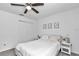 Neutral bedroom with a ceiling fan, white bedding, and decor at 5620 Sw 172Nd Loop, Ocala, FL 34473