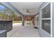 View of the covered patio with ceiling fan, pergola, and outdoor seating, perfect for relaxing and entertaining at 5620 Sw 172Nd Loop, Ocala, FL 34473