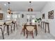 Stylish dining area with modern furnishings and lighting, seamlessly connected to the kitchen and living spaces at 5620 Sw 172Nd Loop, Ocala, FL 34473