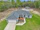 Aerial view of the home showcasing its well-manicured lawn, landscaping, and three-car garage at 5620 Sw 172Nd Loop, Ocala, FL 34473