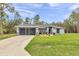 Attractive one-story home with a two-car garage and a well-maintained lawn and landscaped front yard at 5620 Sw 172Nd Loop, Ocala, FL 34473