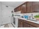Convenient laundry room featuring modern washer and dryer with ample upper and lower storage at 5620 Sw 172Nd Loop, Ocala, FL 34473