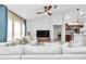 Cozy living room featuring a plush white sofa, a large TV, and views into the adjacent kitchen area at 5620 Sw 172Nd Loop, Ocala, FL 34473