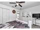 Bright main bedroom with a ceiling fan, a dresser and mirror, and a view into the hallway at 5620 Sw 172Nd Loop, Ocala, FL 34473