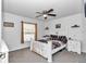 Neutral bedroom with a ceiling fan, window, and a bed with decorative throw blanket at 5620 Sw 172Nd Loop, Ocala, FL 34473
