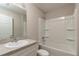 Well-lit bathroom features a single vanity, a mirror and a shower-tub combination at 59 Fisher Ct, Ocklawaha, FL 32179