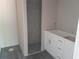 Unfinished bathroom features a walk-in shower and modern white vanity with sleek hardware at 59 Fisher Ct, Ocklawaha, FL 32179