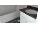 Clean bathroom featuring a white tub and a white vanity with black countertop at 59 Fisher Ct, Ocklawaha, FL 32179