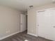 Bright bedroom featuring neutral walls, carpet floors, a closet and an entry door at 59 Fisher Ct, Ocklawaha, FL 32179