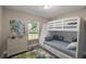 Comfortable bedroom featuring a bunk bed, dresser, stylish decor, and a window providing natural light at 59 Fisher Ct, Ocklawaha, FL 32179