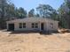 Charming single-story home features a well-manicured lawn, attached garage and inviting entrance at 59 Fisher Ct, Ocklawaha, FL 32179