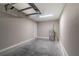 Spacious garage with clean concrete floors, utility connections, and door to the house at 59 Fisher Ct, Ocklawaha, FL 32179