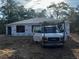 New construction home with wrapped windows and doors with contractor van parked in front at 59 Fisher Ct, Ocklawaha, FL 32179