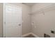 Practical laundry area with overhead shelving and hookups for a washer and dryer at 59 Fisher Ct, Ocklawaha, FL 32179