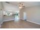 Open concept with luxury vinyl plank flooring with kitchen and backyard access through sliding glass door at 59 Fisher Ct, Ocklawaha, FL 32179