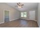 Bright living room boasts vaulted ceilings, ceiling fan, and luxury vinyl plank flooring at 59 Fisher Ct, Ocklawaha, FL 32179