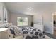 Serene main bedroom with a decorative bed, dresser, soft lighting, and a window offering a pleasant view at 59 Fisher Ct, Ocklawaha, FL 32179