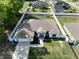 Aerial view of a charming single-story home featuring fenced yard, driveway, and landscaped front at 8330 Se 161St St, Summerfield, FL 34491