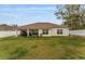 Expansive backyard featuring a covered patio and a pristine white fence, offering privacy and outdoor enjoyment at 8330 Se 161St St, Summerfield, FL 34491