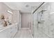 Modern bathroom featuring a marble walk-in shower, vanity, and sleek fixtures at 8330 Se 161St St, Summerfield, FL 34491