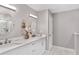 Elegant bathroom with a double vanity, marble countertops, and modern lighting at 8330 Se 161St St, Summerfield, FL 34491