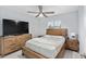 Comfortable bedroom with neutral tones, wood furniture, and ample natural light at 8330 Se 161St St, Summerfield, FL 34491