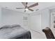 This bedroom has a ceiling fan, tile flooring, and a double-door closet at 8330 Se 161St St, Summerfield, FL 34491