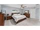 Cozy bedroom with a wood frame bed, wood dresser, and light tile flooring at 8330 Se 161St St, Summerfield, FL 34491