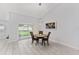 Cozy dining area with a modern chandelier and sliding glass doors to the backyard at 8330 Se 161St St, Summerfield, FL 34491