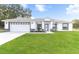 Charming single-story home with a well-manicured lawn and attached two-car garage at 8330 Se 161St St, Summerfield, FL 34491