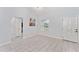 Bright entryway featuring tile floors, a front door with decorative glass, and neutral decor at 8330 Se 161St St, Summerfield, FL 34491