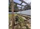 Outdoor garden featuring a wood pergola over multiple planting beds in a fenced yard at 8330 Se 161St St, Summerfield, FL 34491