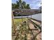 Wooden pergola over an outdoor garden with multiple planting beds in a sunny backyard at 8330 Se 161St St, Summerfield, FL 34491