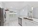 Clean kitchen displaying white cabinets, stainless steel appliances, and marble countertops by a window at 8330 Se 161St St, Summerfield, FL 34491