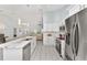 Bright kitchen featuring white cabinetry, stainless steel appliances, and a marble countertop island at 8330 Se 161St St, Summerfield, FL 34491