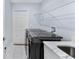 Functional laundry room with modern washer/dryer and a sink with a marble countertop at 8330 Se 161St St, Summerfield, FL 34491