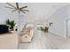 Bright, open-concept living room with tile floors and modern ceiling fan at 8330 Se 161St St, Summerfield, FL 34491