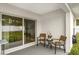 A covered patio features patio chairs, a table, and a sliding glass door entrance at 8330 Se 161St St, Summerfield, FL 34491