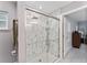 Contemporary bathroom showcasing a walk-in glass shower with marble tile and a rain shower head at 8330 Se 161St St, Summerfield, FL 34491