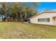 Expansive backyard with lush grass and mature trees, perfect for outdoor activities and relaxation at 8710 Sw 91St Pl # E, Ocala, FL 34481