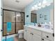 Well-lit bathroom featuring modern fixtures, a glass-enclosed shower, and a vanity at 8710 Sw 91St Pl # E, Ocala, FL 34481