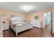 Bright bedroom with hardwood floors, a white bed frame, and abundant natural light at 8710 Sw 91St Pl # E, Ocala, FL 34481