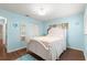 Bright bedroom showcasing wood floors, a white bed, and ample natural light at 8710 Sw 91St Pl # E, Ocala, FL 34481