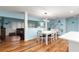 The dining room features wood floors and an open view to the living room at 8710 Sw 91St Pl # E, Ocala, FL 34481