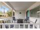 Cozy front porch featuring comfortable seating, white railings and stylish decor with a view of the neighborhood at 8710 Sw 91St Pl # E, Ocala, FL 34481