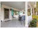 Inviting front porch area featuring comfortable seating and stylish decor, perfect for relaxing outdoors at 8710 Sw 91St Pl # E, Ocala, FL 34481