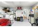 Clean two car garage features epoxy flooring, utility sink, washer and dryer, with additional storage at 8710 Sw 91St Pl # E, Ocala, FL 34481