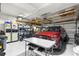 Spacious two car garage featuring ample storage racks, speckled epoxy flooring, and organization at 8710 Sw 91St Pl # E, Ocala, FL 34481
