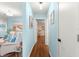Hallway displaying wood floors and access to other rooms in the home at 8710 Sw 91St Pl # E, Ocala, FL 34481