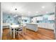 Open kitchen featuring a large center island, modern appliances, and a dining area at 8710 Sw 91St Pl # E, Ocala, FL 34481